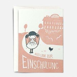 May include: A pink and white card with a cartoon illustration of a girl with a backpack walking towards a school building. The text on the card reads "Alles Liebe zur Einschulung".