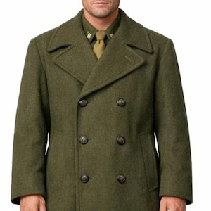 May include: Olive green double-breasted wool coat with a matching hat. The coat features a classic design with large buttons and a tailored fit. The outfit is reminiscent of military attire.