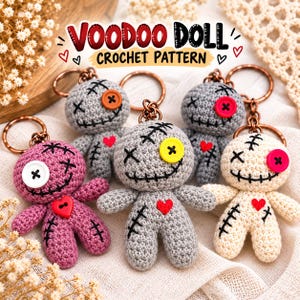 May include: Five small crochet voodoo doll keychains in pink, light gray, dark gray, and cream colors. Each doll features a single button eye, a stitched mouth, a heart-shaped button on the chest, and a metal keyring. Text reads VOODOO DOLL CROCHET PATTERN.