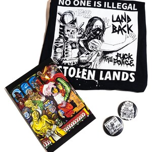 May include: A black graphic tee with the text "NO ONE IS ILLEGAL" and "LAND BACK". A colorful art print and two round buttons with similar graphics are also displayed. The art style is bold and political.