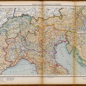 May include: A vintage printed map titled ITALIA SETTENTRIONALE E SVIZZERA, displaying the geography of Northern Italy and Switzerland with detailed topographical lines, regional borders, and a smaller inset map in the upper right corner.