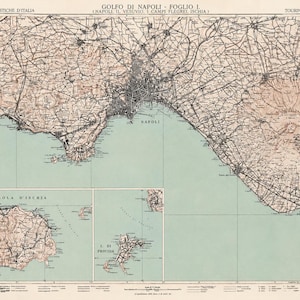 May include: A vintage topographical map titled Golfo di Napoli Foglio I, featuring the Gulf of Naples, Mount Vesuvius, and the Phlegraean Fields. The map includes detailed insets of Ischia and Procida islands, rendered in beige and seafoam green.