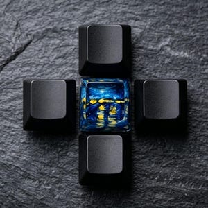 May include: A macro shot of five keyboard keycaps arranged in a cross shape. Four black keycaps surround a central keycap with a blue and yellow abstract design, resembling a landscape or seascape.