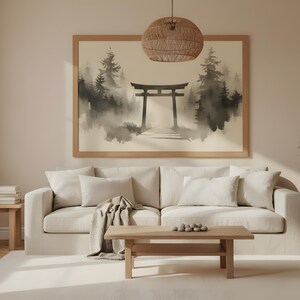 May include: A serene living room scene featuring a beige sofa, wooden coffee table, and side tables. A large framed artwork depicts a Japanese torii gate in a misty forest. A woven pendant light hangs above.