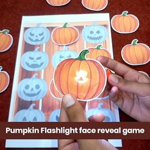 May include: A Pumpkin Flashlight face reveal game featuring a printed sheet with multiple light blue pumpkin outlines and several orange pumpkin cutouts. The orange pumpkin cutouts reveal hidden jack-o'-lantern faces when placed over the light blue pumpkins.