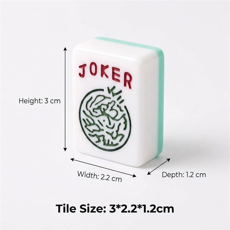 May include: A white Mahjong tile with the word "JOKER" in red, and a green border. The tile features a green circular design. Tile size is 3 cm high, 2.2 cm wide, and 1.2 cm deep.
