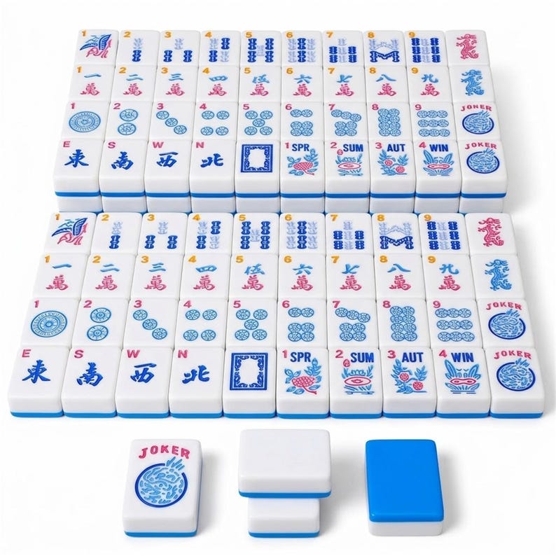 May include: A complete Mahjong set with white tiles featuring blue and red symbols and characters. The set includes tiles with numbers, suits, and special symbols, along with white and blue accessories. The tiles are neatly arranged.