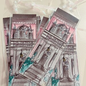 May include: A stack of four pink and gray bookmarks with a watercolor illustration of a building with the text "The Olde Pink House Restaurant & Tavern".