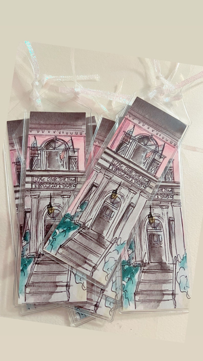 May include: A stack of four pink and gray bookmarks with a watercolor illustration of a building with the text "The Olde Pink House Restaurant & Tavern".