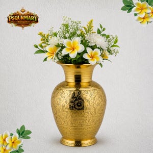 May include: A gold-colored vase with an etched floral design, filled with a bouquet of white and yellow flowers. The vase has a wide base and a flared top. The image also includes the text "PSQURMART ONLINE SHOP".