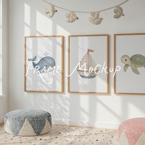 May include: Three framed art prints with watercolor illustrations of a whale, sailboat, and turtle. The frames are light wood, and the prints are displayed on a white wall. The text "Frame Mockup" is written on the prints.