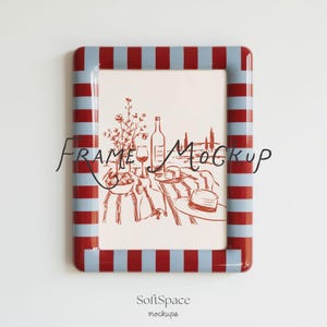 May include: A rectangular picture frame featuring a repeating pattern of vertical red and light blue stripes. The frame encloses a white print with a red line drawing of a table setting, including a wine bottle, glass, and a hat.