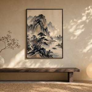 May include: A framed vertical wall art print featuring a landscape painting with ink-wash style mountains, pine trees, a river, and a small boat. The artwork is displayed on a beige wall above a dark wooden bench with a vase and a round paper lamp.