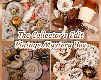 May include: A selection of vintage items, including plates, teacups, a swan figurine, and decorative objects. The items are arranged on a burlap surface. The text "The Collector's Edit Vintage Mystery Box" is displayed in the center.