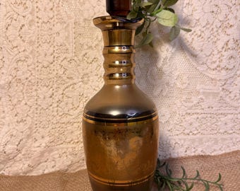 Vintage Bohemian glass decanter with gold floral pattern and stopper.