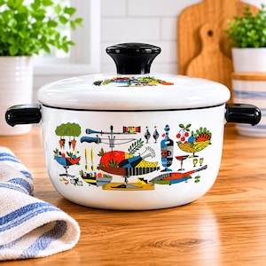 May include: A white enamel cooking pot with a black lid handle and side handles. The exterior features a colorful graphic print of various food items, including a roasted chicken, fruits, vegetables, and kitchen utensils in red, blue, and green.