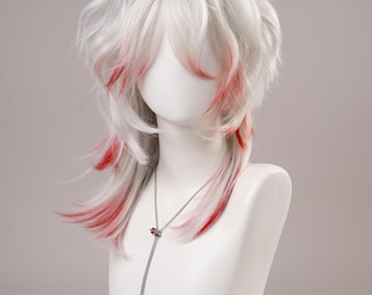 May include: A layered white wig with vibrant red highlights throughout the hair. The wig features a shaggy, shoulder-length cut with textured bangs and side-swept layers. A thin silver chain necklace with a small red accent rests on the neck.