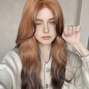 May include: A long, wavy wig featuring a gradient color transition from a warm ginger-orange at the roots to a deep, dark brown at the ends. The hair is parted in the center, with face-framing layers that blend the two distinct color tones.