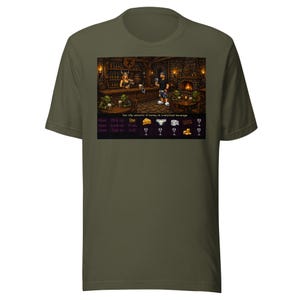 May include: Olive green t-shirt featuring a pixelated image of a tavern scene. The image includes characters, a bar, and text that reads "Use silly amounts of money on overpriced beverage." Below the image are more pixelated icons.