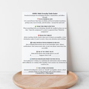 Peut inclure: Une carte d'information blanche intitul&eacute;e ADHD: Make Everyday Tasks Easier, avec du texte noir et de petites ic&ocirc;nes color&eacute;es. La carte &eacute;num&egrave;re des strat&eacute;gies pratiques pour g&eacute;rer l'attention et l'organisation, incluant des conseils.