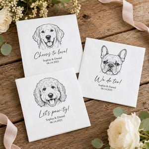 May include: Three square white paper napkins featuring black line art illustrations of dog faces. Each napkin displays custom text including Cheers to love!, We do too!, and Let's paw-ty!, along with the names Sophia & Daniel and the date 06.14.2025.