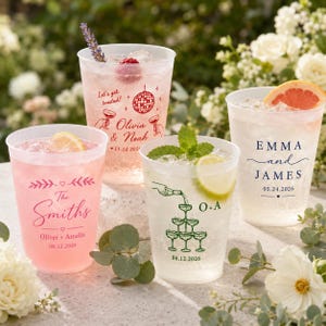 May include: Four clear plastic cups filled with ice and beverages, each featuring custom printed text and graphics. Designs include names, dates, and illustrations like a disco ball, a champagne tower, and floral accents, garnished with fruit and herbs.