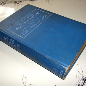 May include: A blue hardcover book titled "Dyke's Automobile and Gasoline Engine Encyclopedia".