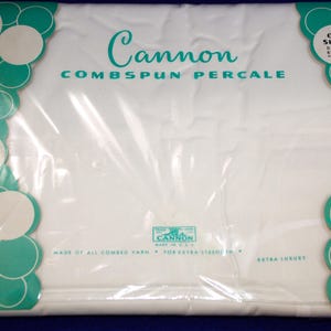 May include: A white Cannon Combspun Percale double sheet in original packaging. The packaging features teal scalloped edges with white circles and text reading Cannon, Combspun Percale, One Sheet Double 81 x 108, and Made of All Combed Yarn.