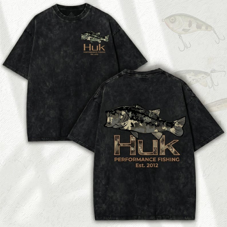 May include: Black t-shirt with a camouflage bass graphic and the text "Huk PERFORMANCE FISHING Est. 2012." The shirt has a distressed, vintage look. The design is repeated on the front and back.