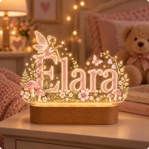 May include: A custom illuminated acrylic sign featuring the name Elara in soft pink lettering. The design includes a fairy silhouette, butterflies, small flowers, and mushrooms, all mounted on a rectangular wooden base that emits a warm glow.