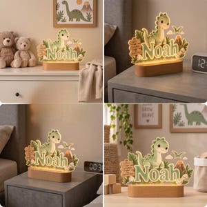 Puede incluir: Un letrero de acr&iacute;lico iluminado con un dinosaurio de dibujos animados, un volc&aacute;n y el nombre Noah en letras verdes. El dise&ntilde;o incluye una base de madera y el texto Little Explorer Big Adventures, iluminado con un brillo c&aacute;lido y suave.