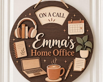 May include: A circular dark wood sign with a rope hanger featuring the text "ON A CALL" and "Emma's Home Office." The sign includes layered wooden cutouts of headphones, a calendar, a notebook, a laptop, a coffee mug, a pen, and a potted plant.