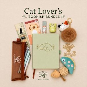 May include: A stationery set featuring a sage green notebook with a cat illustration, a brown pencil case, a black cat bookmark, a cat-themed notepad, a green cat figurine, a cat keychain with a brown pom-pom, and cat-shaped paper clips.
