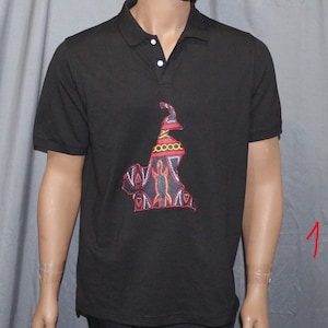 May include: Black polo shirt with an embroidered outline of Cameroon in red, yellow, and black.