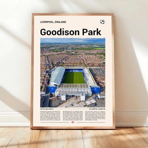 May include: A framed print of Goodison Park, a soccer stadium in Liverpool, England. The image shows an aerial view of the stadium with a green field and blue seating. Text includes the stadium name, location, and a soccer ball icon.