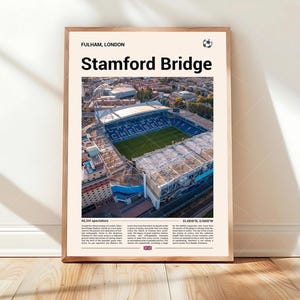 May include: A framed print featuring an aerial view of Stamford Bridge stadium in London. The print includes the text "Fulham, London" and "Stamford Bridge" in bold letters. The stadium is shown with a green field and blue seating.