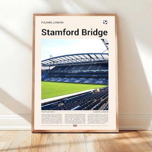 May include: A framed print featuring Stamford Bridge stadium in Fulham, London. The image shows the stadium's interior with green field and blue seating. Text at the top reads "Stamford Bridge" and "FULHAM, LONDON".