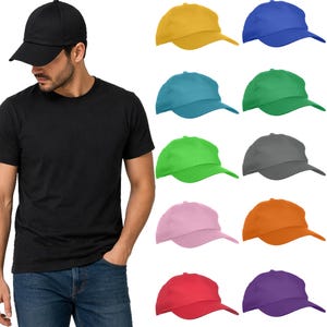 May include: A man wearing a black baseball cap and t-shirt, with a selection of colourful baseball caps. The caps are in yellow, blue, teal, green, grey, pink, orange, red, and purple. The caps have a curved peak and adjustable strap.