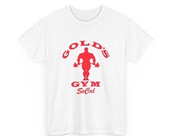May include: A white short-sleeved t-shirt featuring a red graphic print on the chest. The design displays the text GOLD'S GYM in an arch above a silhouette of a bodybuilder holding a barbell, with the text GYM SoCal printed below.