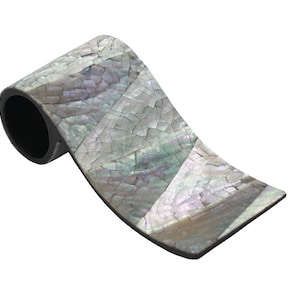 May include: A decorative, iridescent, mother-of-pearl napkin ring with a black base.