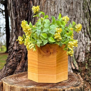 May include: A rustic wooden sign with the text "Welcome to our home" in white lettering. The sign features a distressed finish and a simple, inviting design, perfect for entryway decor.