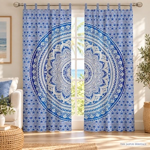 May include: A pair of blue and white curtains featuring a large central mandala pattern and a repeating geometric border design. The curtains are hung from a metal rod using fabric tabs at the top, displaying a detailed circular motif.