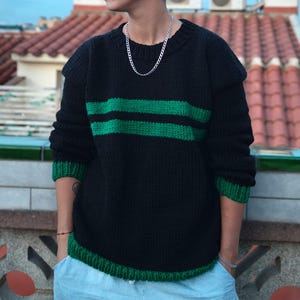 May include: A white ceramic mug with a black handle and the text "But First, Coffee" in a black, handwritten-style font. The mug is on a white surface.