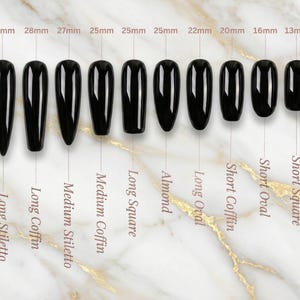 May include: Ten glossy black artificial nails are displayed, varying in shape and size from 13mm to 30mm. Nail styles include Long Stiletto, Long Coffin, Medium Stiletto, Medium Coffin, Long Square, Almond, Long Oval, Short Coffin, Short Oval, and Short Square.