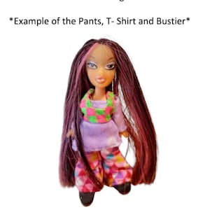 May include: A doll with long dark hair featuring pink highlights, wearing a green and pink checkered bustier over a light purple long-sleeved shirt, and patterned pants with a multi-colored diamond design. Text reads: Example of the Pants, T-Shirt and Bustier.