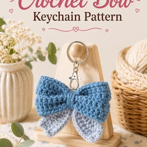 May include: A crochet bow keychain featuring a two-tone design with a dark blue upper bow and a light blue lower bow. The item includes a silver metal keyring and a lobster clasp. The text Crochet Bow Keychain Pattern is displayed above the object.