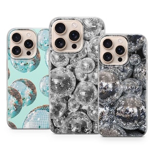 May include: Three phone cases with disco ball designs. One case has a light blue background with disco balls, while the other two feature silver disco balls. The cases have camera cutouts and a clear, protective design.