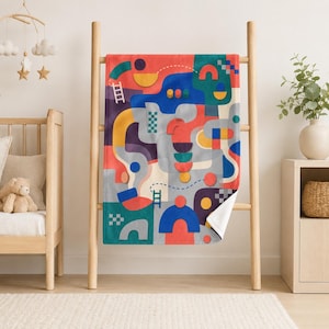 May include: A rectangular throw blanket featuring a vibrant abstract pattern of geometric shapes including circles, semicircles, and curved lines in shades of red, blue, yellow, teal, and grey, accented with small white ladder and dotted line motifs.