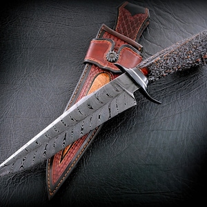 May include: A white ceramic mug with a black handle and the text "But First, Coffee" in a handwritten style. The mug is on a white surface. The mug is likely for hot beverages.