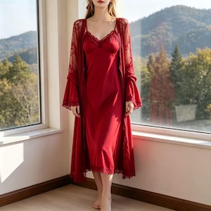 May include: A red satin nightgown and matching lace-trimmed robe. The nightgown has a V-neckline and spaghetti straps. The robe features long sleeves and a delicate lace design. The set is made of a soft, flowing fabric, perfect for lounging.